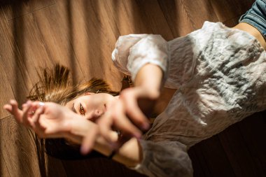 Yüzünde ve vücudunda çizgiler şeklinde gölge desenleri olan güzel bir genç kızın portresi. Moda, güzellik. Yeşil yapraklı kadın köprücük kemiği, alçı..