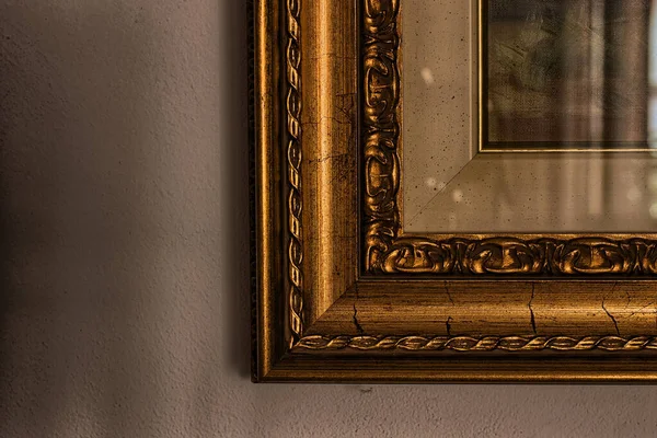 A small portion o a corner of A frame of a painting