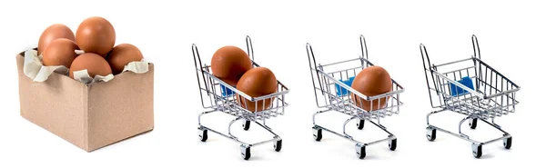 Box and three mini carts with eggs isolated on white background, loss of wealth concept. Decrease in the number of eggs.