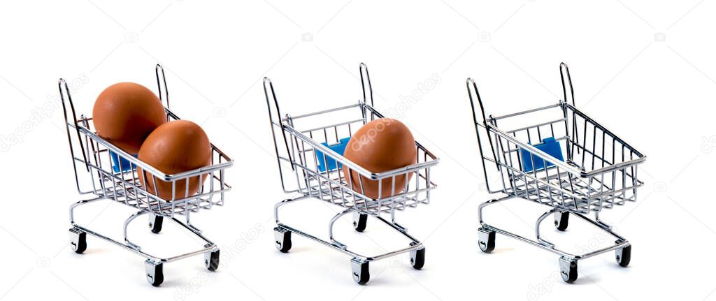 Three mini carts with eggs isolated on white background, loss of wealth and price increase metaphor concept. Decreasing in the number of eggs.