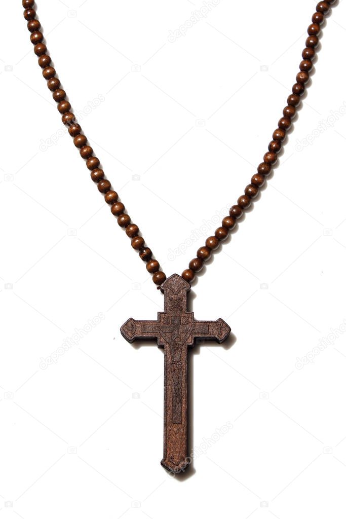 Wooden christian cross necklace isolation on white background