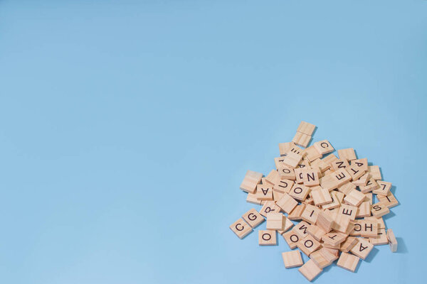 wooden alphabet a bunch letters on the surface of a blue background