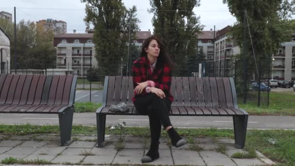 Young Depressed Homeless Girl Woman Hat Sitting Alone Bench Street — Stock Video