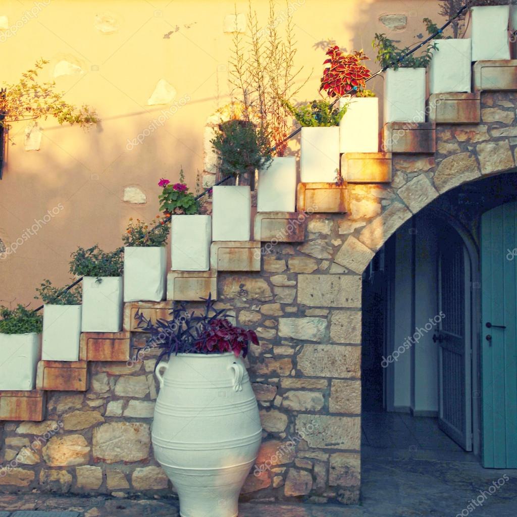 Flower pots on the staircase in old stone house, Crete, Greece Stock