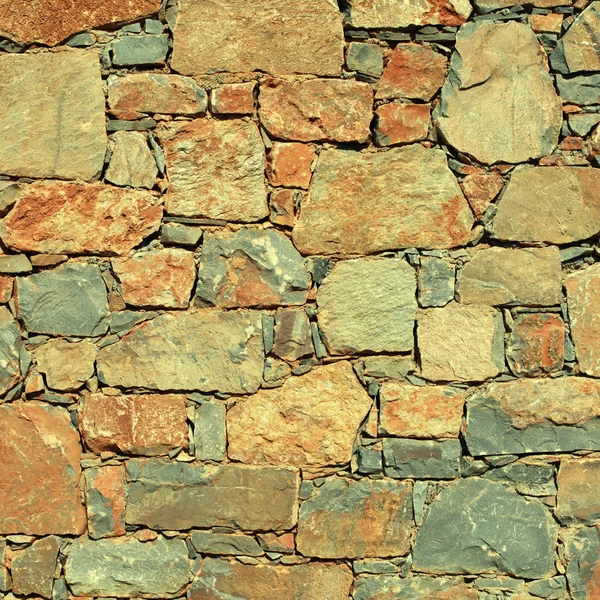 Pared de piedra mediterránea áspera como fondo . — Foto de Stock