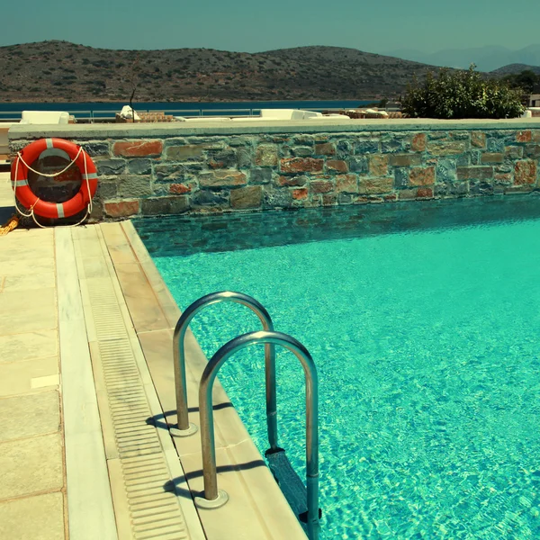 Patio and resort pool overlooking the Mediterranean sea — Stock Photo, Image