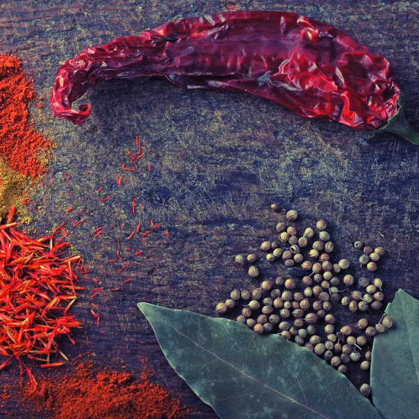 Spices on a old wooden cutting board — Stock Photo, Image