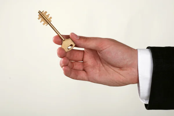 Businessman with a key in his hand — Stock Photo, Image
