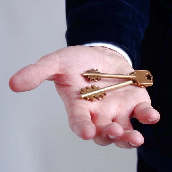 Businessman with a key in his hand — Stock Photo, Image