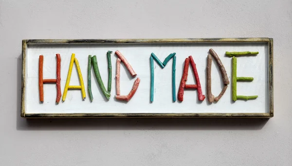 Sign with colorful wooden letters forming word "hand made" — Stock Photo, Image