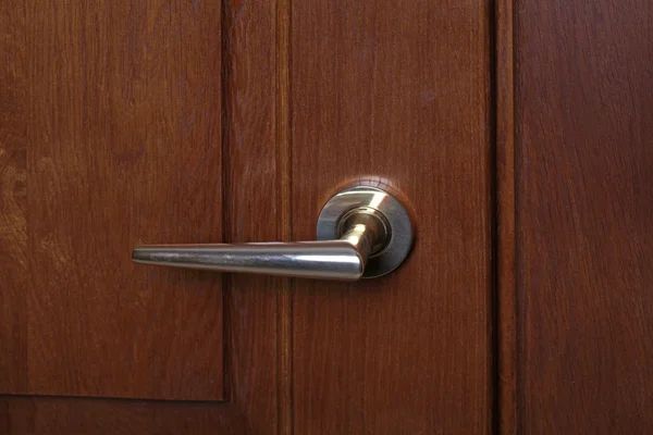 Modern style door handle on natural wooden door — Stock Photo, Image