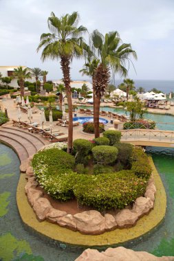 Tropical resort hotel with palm trees and swimming pool, Sharm el Sheikh, Egypt.