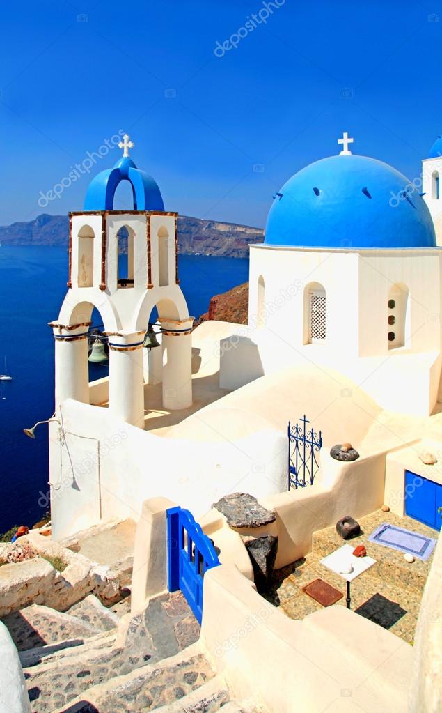 white and blue orthodox church in the village of Oia, Santorini 