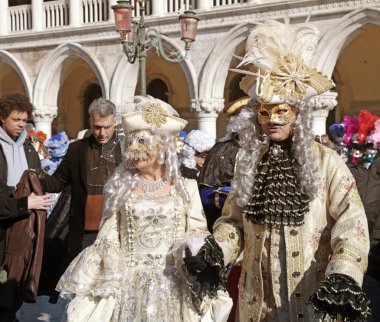 masked persons in costume on San Marco Square, Venice, Italy.