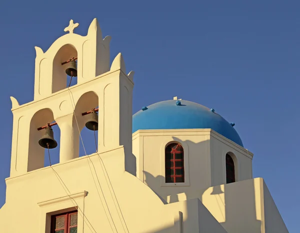 Blauw koepel Grieks orthodoxe kerk en klokkentoren in Oia op Santorin — Stockfoto