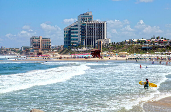 Sand beach of the Mediterranean sea and modern hotels in Herzliya, Israel