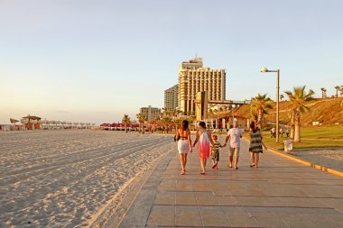  People on the beach promenade and modern hotels in Herzliya, Is