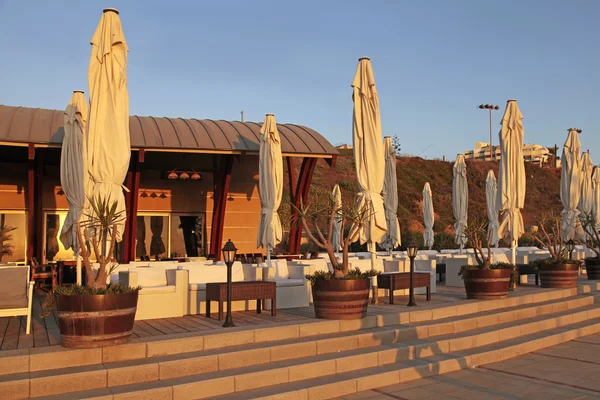 Beach cafe on the sea at sunset — Stock Fotó