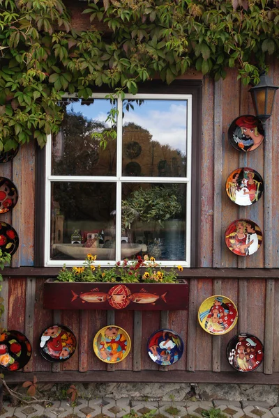 Rustic window with ceramic plates in wood rural house — Stock Photo, Image