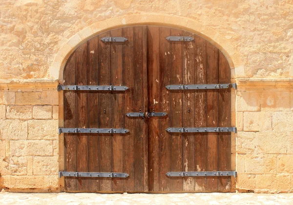 Large wooden door with wrought-iron elements. Decorative door with ... Large wooden door with wrought-iron elements. Decorative door with ...