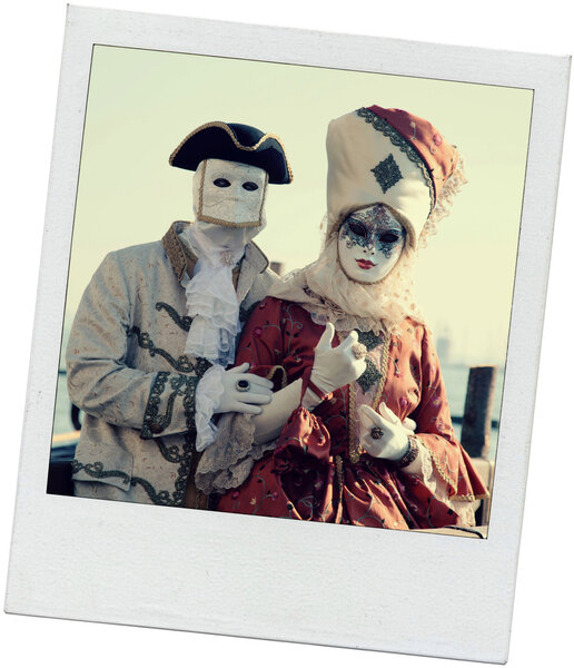Costumed couple in Venetian mask during Venice Carnival 