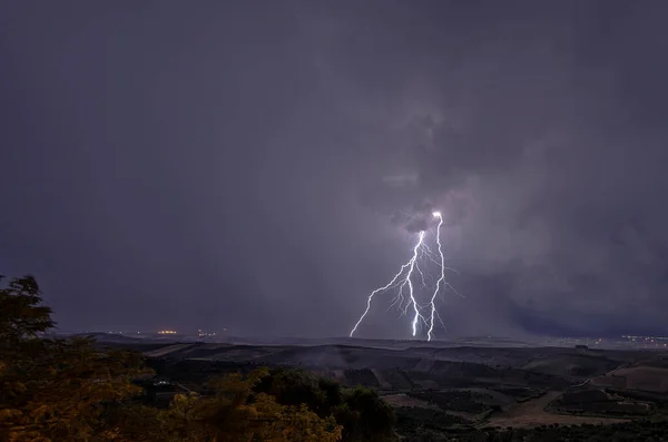 Beautiful night sky with lightning and thunderbolts during a thunderstorm in the countryside