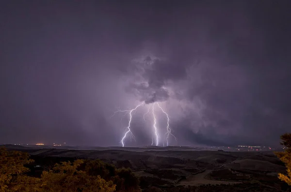 Beautiful night sky with lightning and thunderbolts during a thunderstorm in the countryside