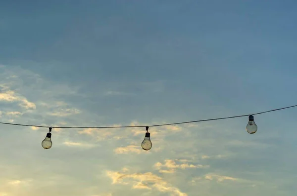 Row of light bulbs hanging outdoors