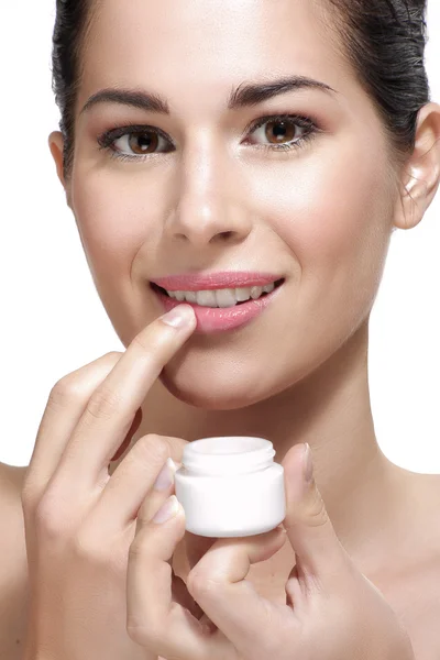Young beautiful woman applying cream treatment on skin — Stock Photo, Image