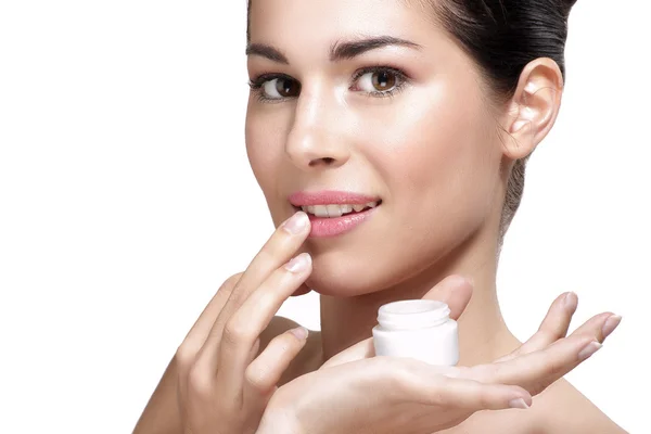 Young beautiful woman applying cream treatment on skin — Stock Photo, Image