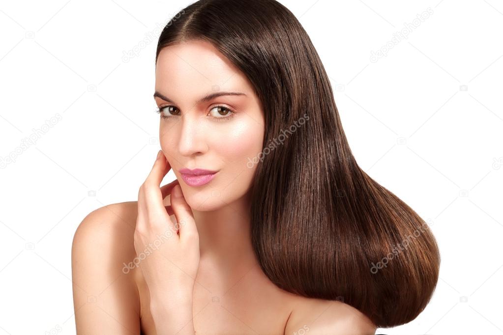 Beauty model showing perfect skin and long healthy brown hair