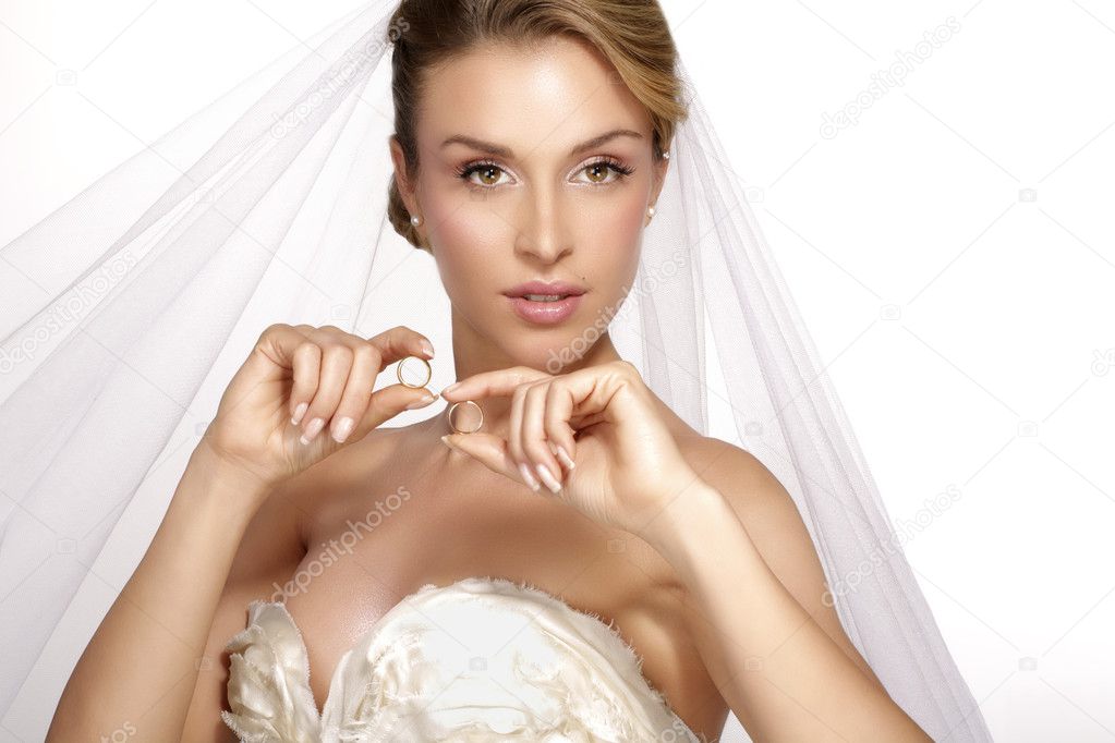 portrait of  young woman in wedding dress posing with white brid