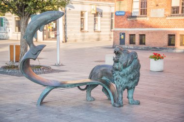 The Lion and the fish sculpture on market square in Puck, Poland clipart
