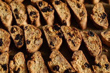 Homemade italian cantuccini biscotti cookies with hazelnuts and dried cranberries on baking paper