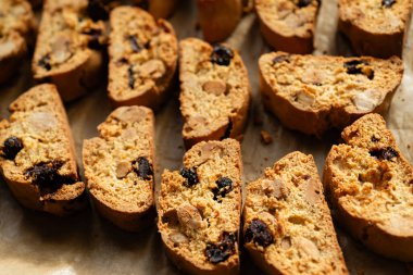 Homemade italian cantuccini biscotti cookies with hazelnuts and dried cranberries on baking paper