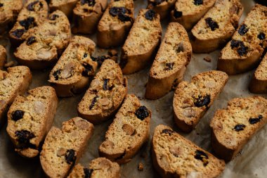 Homemade italian cantuccini biscotti cookies with hazelnuts and dried cranberries on baking paper