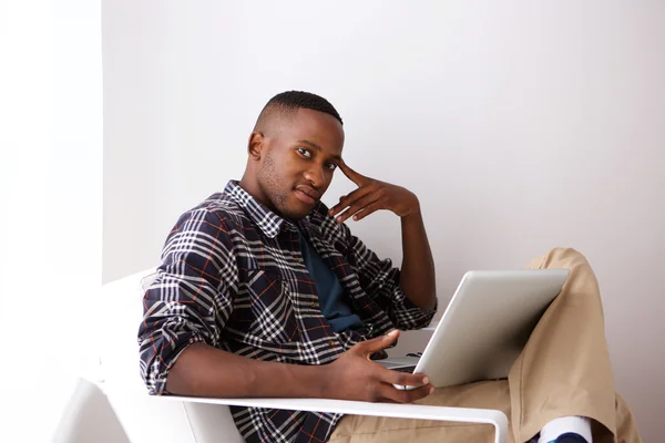 Unga afrikanska kille med en bärbar dator — Stockfoto