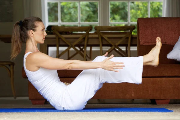 Donna di yoga che esercita sollevando le gambe — Foto Stock