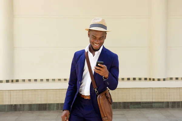 Happy guy with bag and mobile phone — Stock Photo, Image