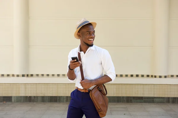 Young african guy with a mobile phone