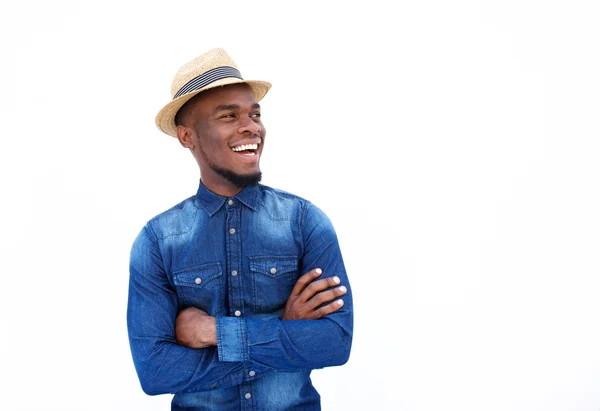 Cheerful young man standing with hat — Stock Photo, Image