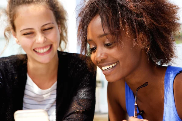 Two friends looking at mobile phone — Stock Photo, Image