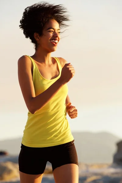 Smiling sports woman running outdoors — Stock Photo, Image