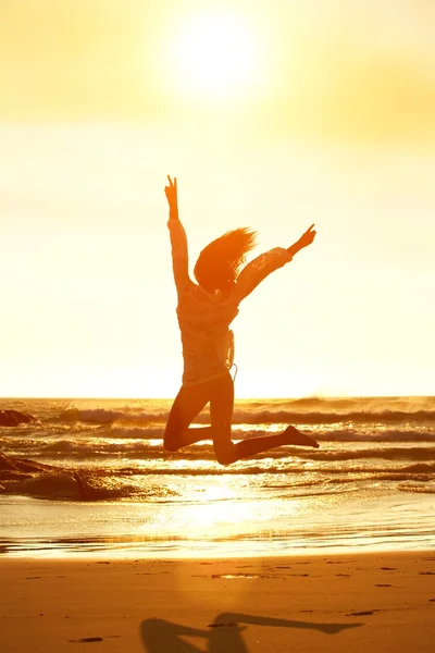 Frau springt vor Freude am Strand — Stockfoto