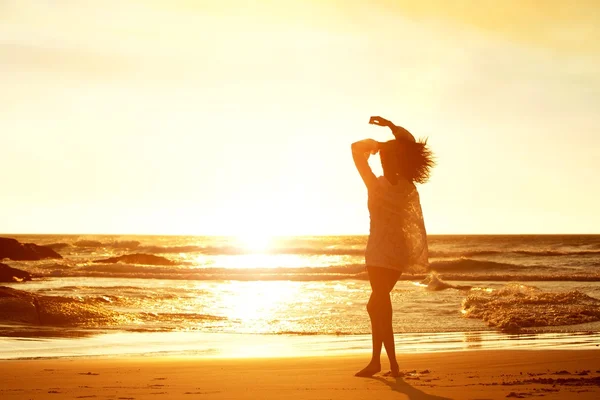 Silueta mujer joven caminando en la playa — Foto de Stock