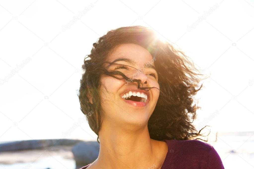 Young woman laughing outdoors