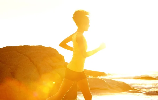 Young fitness woman running by the sea — Stock Photo, Image