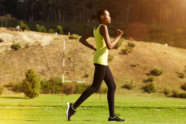 Joven mujer africana corriendo al aire libre — Foto de Stock