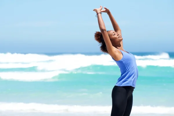 Fitness woman stretching at the beach — Stock Photo, Image