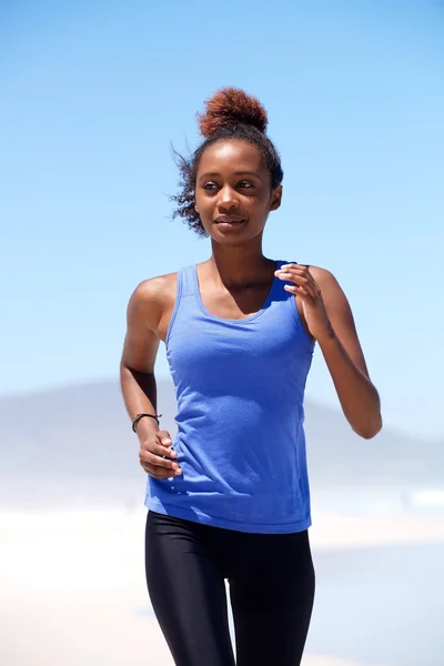 Young woman running at the beach — Stock Photo, Image